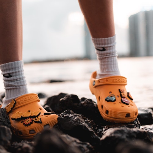 child standing with crocs 