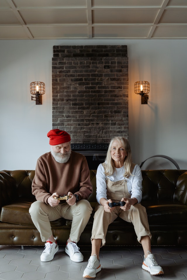 Man & Woman Sitting On Couch